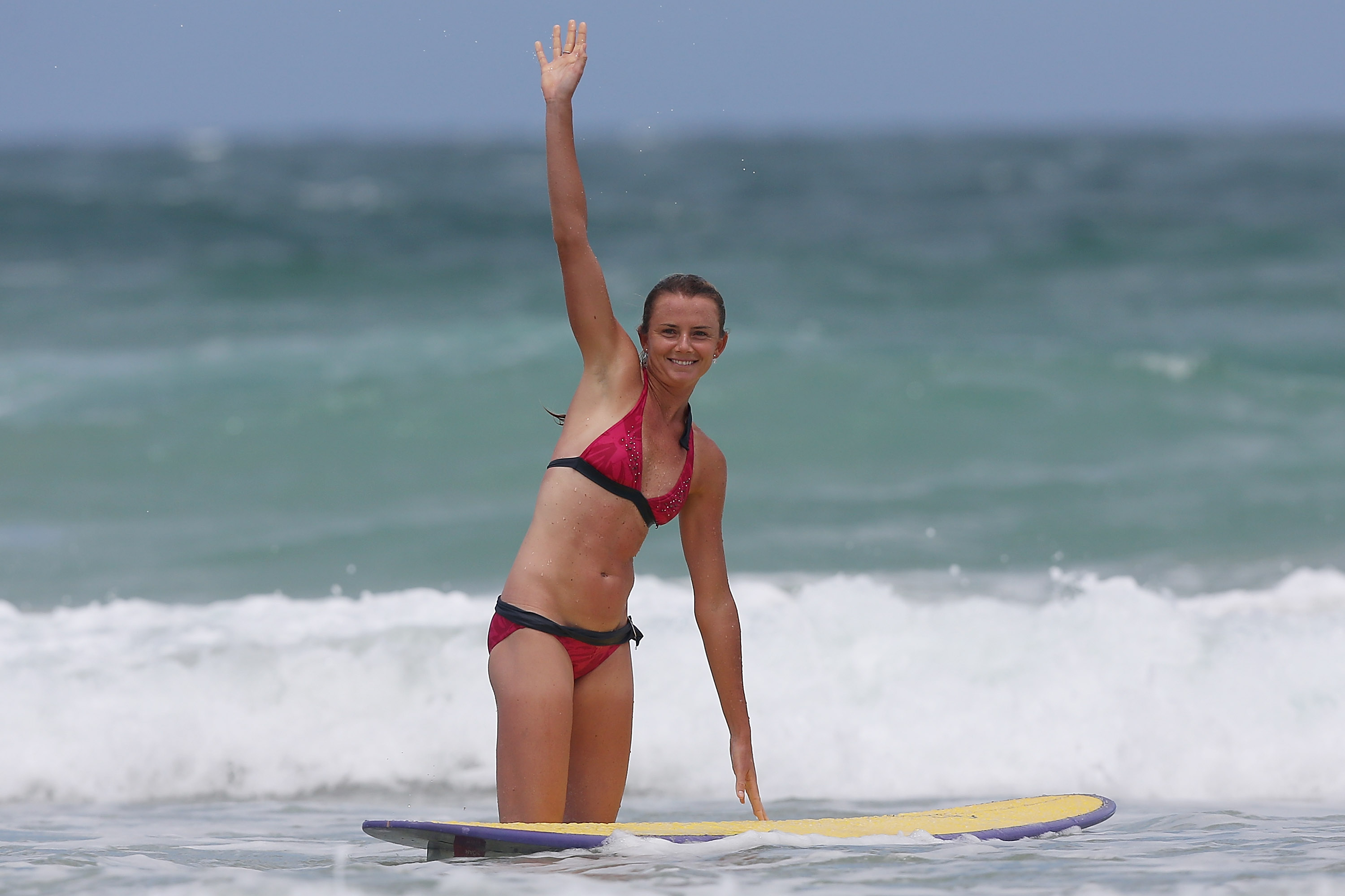 SUNSHINE COAST, AUSTRALIA - DECEMBER 27: Slovakian tennis player Daniela Hantuchova waves during a surf lesson with pro surfer Julian Wilson at Coolum Beach on December 27, 2012 in Sunshine Coast, Australia. (Photo by Chris Hyde/Getty Images)
