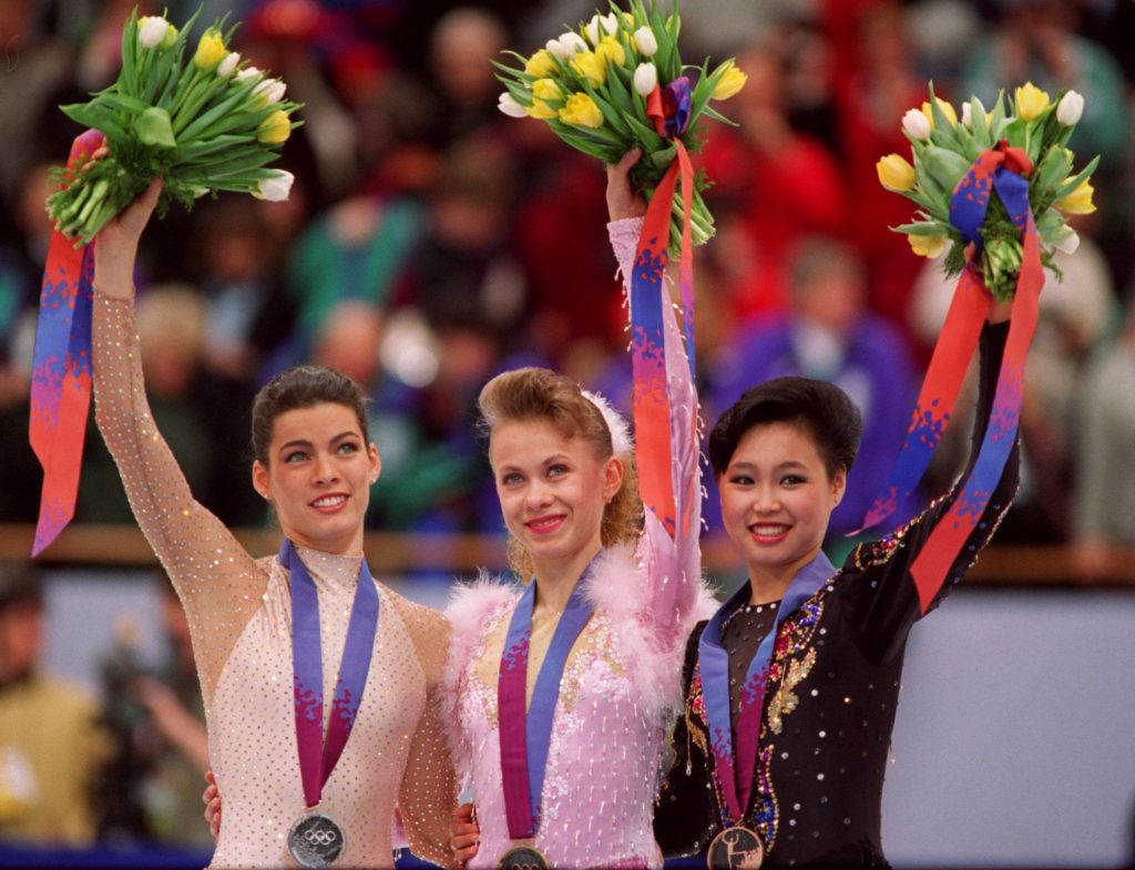 25 FEB 1994: OKSANA BAIUL OF THE UKRAINE 1ST (CENTER), NANCY KERRIGAN OF THE USA 2ND (LEFT) AND LU CHEN OF CHINA, 3RD, ON THE MEDAL STAND TODAY IN THE LADIES FIGURE SKATING COMPATITION AT THE 1994 WINTER OLYMPIC GAMES IN LILLEHAMMER. Mandatory Credit:Mike Powell/ALLSPORT