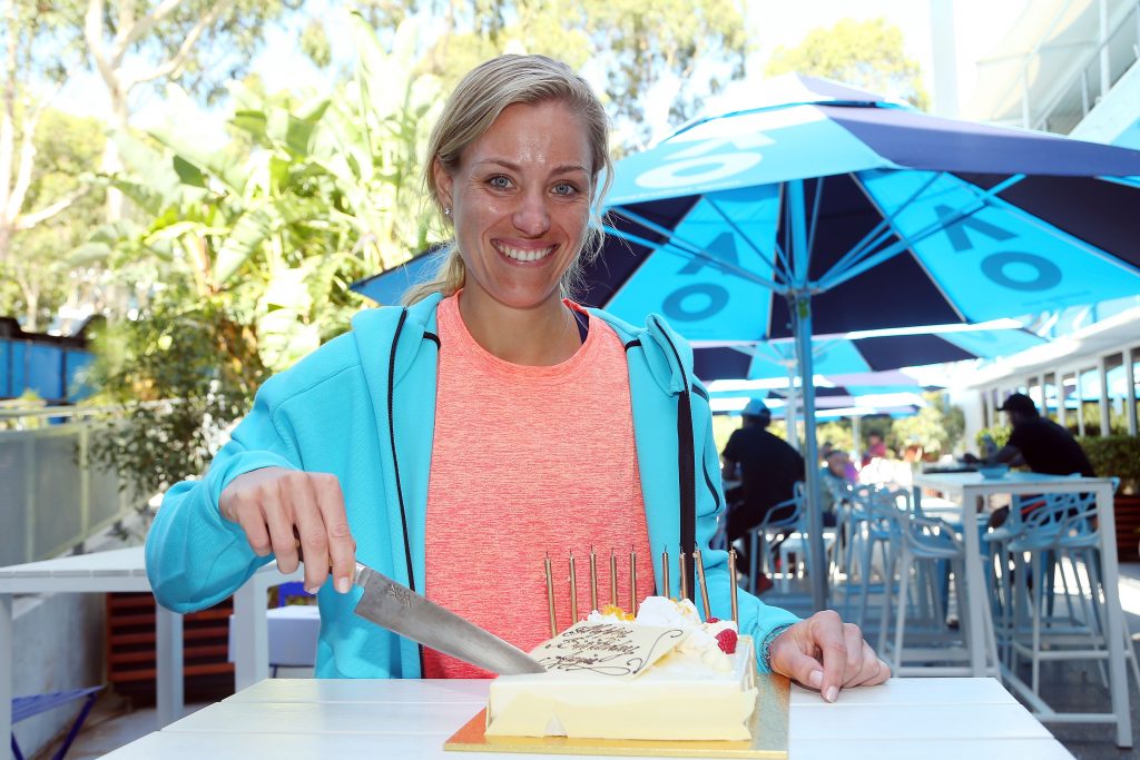 MELBOURNE, AUSTRALIA - JANUARY 18: Angelique Kerber of Germany poses with a birthday cake which was presented to her by Australian Open Tournament Director Craig Tiley during day three of the 2017 Australian Open at Melbourne Park on January 18, 2017 in Melbourne, Australia. (Photo by Graham Denholm/Getty Images)