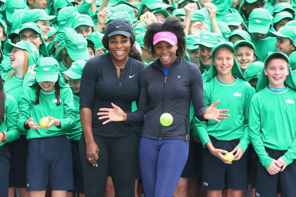 MELBOURNE, AUSTRALIA - JANUARY 10: Serena Williams (L) and sister Venus Williams of the USA pose with over 380 Australian Open ballkids for the annual welcome ceremony during a practice session ahead of the 2017 Australian Open at Melbourne Park on January 10, 2017 in Melbourne, Australia. (Photo by Michael Dodge/Getty Images)