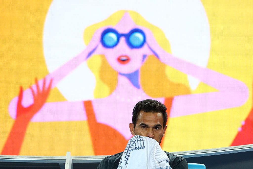 MELBOURNE, AUSTRALIA - JANUARY 18: Victor Estrella Burgos of The Dominican Republic rests between games during his second round match against Bernard Tomic of Australia on day three of the 2017 Australian Open at Melbourne Park on January 18, 2017 in Melbourne, Australia. (Photo by Cameron Spencer/Getty Images)
