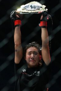 SINGAPORE - MAY 06: Angela Lee of Singapore celebrates after defeating Mei Yamaguchi of Japan in the women??s atomweight world championship bout during One Chamionship: Ascent to Power at Singapore Indoor Stadium on May 6, 2016 in Singapore. (Photo by Suhaimi Abdullah/Getty Images)