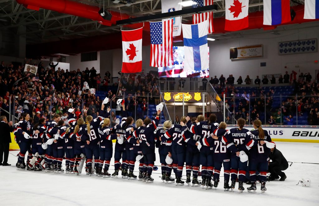 PLYMOUTH, MI - APRIL 07: The United States watches their flag rise after a 3-2 overtime win over Canada in the gold medal game at the 2017 IIHF Woman's World Championships at USA Hockey Arena on April 7, 2017 in Plymouth, Michigan. (Photo by Gregory Shamus/Getty Images)