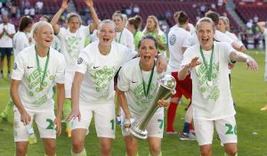 COLOGNE, GERMANY - MAY 27: Pernille Harder of Wolfsburg (L), Axandra Popp of Wolfsburg, (2.L), Sara Bjoerk Gunnarsdottir of Wolfsburg (2.R) and Caroline Graham Hansen of Wolfsburg celebrate the winning of the trophy during the Women's DFB Cup Final 2017 match between SC Sand and VFL Wolfsburg at RheinEnergieStadion on May 27, 2017 in Cologne, Germany. (Photo by Mika Volkmann/Bongarts/Getty Images)