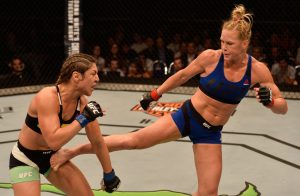SINGAPORE - JUNE 17: (R-L) Holly Holm kicks Bethe Correia of Brazil in their women's bantamweight bout during the UFC Fight Night event at the Singapore Indoor Stadium on June 17, 2017 in Singapore. (Photo by Brandon Magnus/Zuffa LLC/Zuffa LLC via Getty Images)