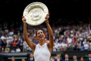 LONDON, ENGLAND - JULY 15: Garbine Muguruza of Spain celebrates victory with the trophy after the Ladies Singles final against Venus Williams of The United States on day twelve of the Wimbledon Lawn Tennis Championships at the All England Lawn Tennis and Croquet Club at Wimbledon on July 15, 2017 in London, England. (Photo by Shaun Botterill/Getty Images)